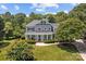 Stunning two-story home with a large covered front porch, green front door, and well-manicured lawn at 110 Lynbrook Dr, Davidson, NC 28036