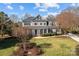 Stunning two-story home with manicured lawn, lush landscaping, and a welcoming front porch at 110 Lynbrook Dr, Davidson, NC 28036