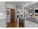 Open-concept kitchen with a wine cooler and a wooden sliding barn door at 110 Lynbrook Dr, Davidson, NC 28036