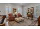 Traditional living room with hardwood floors, shuttered windows, area rug, and comfortable seating at 110 Lynbrook Dr, Davidson, NC 28036