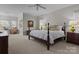 Bright main bedroom with neutral walls, natural light, and four-poster bed at 110 Lynbrook Dr, Davidson, NC 28036