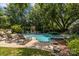 Inviting backyard pool with lounge chairs and a stone fireplace perfect for outdoor entertaining at 110 Lynbrook Dr, Davidson, NC 28036