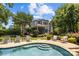 Inviting backyard pool with tanning ledge and surrounding patio with chairs, perfect for outdoor living at 110 Lynbrook Dr, Davidson, NC 28036