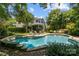 Beautiful backyard pool with stone accents and lounge chairs, surrounded by lush landscaping at 110 Lynbrook Dr, Davidson, NC 28036