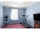 Simple bedroom with carpet flooring, and home exercise equipment at 111 Green Dr, Richburg, SC 29729