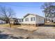 Front view of a white doublewide home with blue shutters and a gravel driveway at 111 Green Dr, Richburg, SC 29729