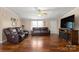 Living room with hardwood floors, leather furniture, and a large TV at 111 Green Dr, Richburg, SC 29729