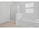 Bathroom showcasing a soaking tub, glass shower, and tiled flooring at 1115 Ross Brook Trce, York, SC 29745