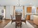 Cozy dining area with natural light and outdoor views, featuring a round glass table and wicker chairs at 1115 Ross Brook Trce, York, SC 29745