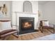 Close-up of a fireplace with decorative mantle and hearth, flanked by stylish seating and horse-themed art at 1115 Ross Brook Trce, York, SC 29745