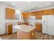 Well-lit kitchen with light wood cabinets, an island, and modern appliances for everyday cooking at 1115 Ross Brook Trce, York, SC 29745