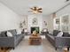 Comfortable living room with stylish sofas, a cozy fireplace, and natural light from the windows at 1115 Ross Brook Trce, York, SC 29745