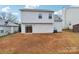 View of the home's backyard featuring the siding and a sliding glass door at 12218 Stewarts Crossing Dr, Charlotte, NC 28215