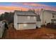 Backyard view of home with sliding glass door and dusk sky at 12218 Stewarts Crossing Dr, Charlotte, NC 28215