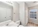 Bright bathroom with a big mirror, tile floors, and a shower/tub combo at 12218 Stewarts Crossing Dr, Charlotte, NC 28215