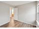 Bedroom with wood-look floors and a glimpse into the adjacent bathroom at 12218 Stewarts Crossing Dr, Charlotte, NC 28215