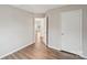 Bright bedroom with hardwood floors and a view into another room at 12218 Stewarts Crossing Dr, Charlotte, NC 28215