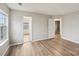 Bright bedroom with hardwood floors leading to another room and closet at 12218 Stewarts Crossing Dr, Charlotte, NC 28215