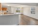 Bright dining room featuring stainless steel appliances, hardwood floors, and a view to the yard at 12218 Stewarts Crossing Dr, Charlotte, NC 28215