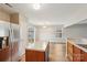 Bright kitchen with white countertop island, stainless steel refrigerator, wood cabinets and laminate wood floors at 12218 Stewarts Crossing Dr, Charlotte, NC 28215