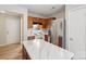 Efficient kitchen with marble countertop island, white appliances, and wood cabinetry at 12218 Stewarts Crossing Dr, Charlotte, NC 28215