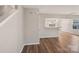 Bright living room with laminate wood floors and an open layout to the adjacent kitchen area at 12218 Stewarts Crossing Dr, Charlotte, NC 28215