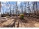 Landscaped backyard with mature trees and concrete patio at 1308 Gum Branch Rd, Charlotte, NC 28214