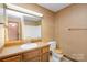 Bathroom with single sink vanity and shower/tub combo at 1308 Gum Branch Rd, Charlotte, NC 28214