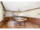 Game room with pool table and wood paneling at 1308 Gum Branch Rd, Charlotte, NC 28214