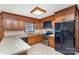 Kitchen with wood cabinets, tile countertops, and stainless steel appliances at 1308 Gum Branch Rd, Charlotte, NC 28214