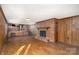 Spacious living room with brick fireplace and hardwood floors at 1308 Gum Branch Rd, Charlotte, NC 28214