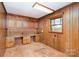 Home office with wood paneling and built-in cabinetry at 1308 Gum Branch Rd, Charlotte, NC 28214