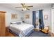 Cozy bedroom with striped bedding, ceiling fan, and ample closet space at 1318 Gum Branch Rd, Charlotte, NC 28214