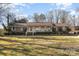 Brick ranch house with covered porch and spacious lawn at 1318 Gum Branch Rd, Charlotte, NC 28214