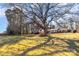 Ranch home nestled on a lot with a large tree at 1318 Gum Branch Rd, Charlotte, NC 28214