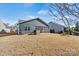 The house is shown from the backyard featuring the outdoor fireplace and screened in porch at 132 Picasso Trl, Mount Holly, NC 28120