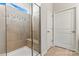 Modern bathroom featuring a tiled shower with glass door, bench, and decorative tile border at 132 Picasso Trl, Mount Holly, NC 28120