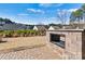 Backyard stone fireplace on brick patio with a view of lawn and trees adds warmth to outdoor space at 132 Picasso Trl, Mount Holly, NC 28120