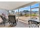 Comfortable outdoor seating on a screened porch, overlooking the backyard and neighborhood at 132 Picasso Trl, Mount Holly, NC 28120