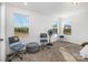 Bright bedroom featuring three windows, plush carpeting, and neutral decor, creating a comfortable and inviting space at 1433 Harleston St, Indian Trail, NC 28079