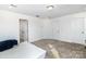 Neutral carpeted bedroom with two entry doors, recessed lighting, and a view of the home's surroundings at 1433 Harleston St, Indian Trail, NC 28079