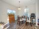 Bright dining area with laminate flooring, natural light, and a view of the outdoors at 1433 Harleston St, Indian Trail, NC 28079