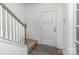 Welcoming entryway featuring stairs with white banister and a natural colored wood-look flooring at 1433 Harleston St, Indian Trail, NC 28079