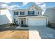 Attractive two-story home with attached two-car garage and manicured lawn at 1433 Harleston St, Indian Trail, NC 28079