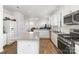 Modern kitchen with stainless steel appliances, granite countertops, island, and view to living area at 1433 Harleston St, Indian Trail, NC 28079