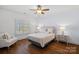 Well-lit bedroom with hardwood floors and a ceiling fan at 20517 Queensdale Dr, Cornelius, NC 28031