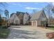 Two-story house with stone accents, three-car garage, and basketball court at 20517 Queensdale Dr, Cornelius, NC 28031