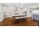 Bright kitchen boasts an island with seating and hardwood floors at 20517 Queensdale Dr, Cornelius, NC 28031