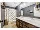 Bathroom with double sink vanity, grey walls, neutral tile, and Mickey Mouse shower curtain at 2222 Bluebell Way, Fort Mill, SC 29708