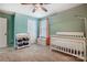 This bedroom boasts a white crib and is painted green at 2222 Bluebell Way, Fort Mill, SC 29708